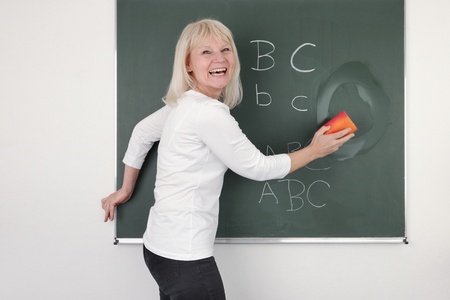 Teacher cleaning the chalkboard, suits horizontal composition の写真素材