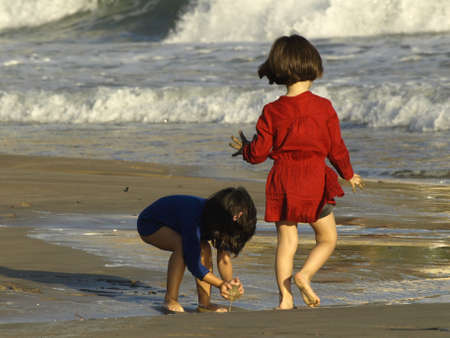 children playing on the shore of a mediterranean beachの写真素材