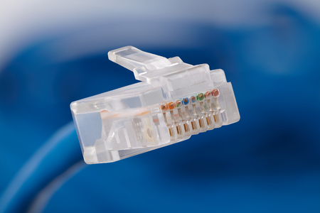 Internet cable, connector close up on an abstract blue background