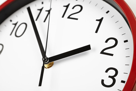 black and white clock face, midday on the clock, time close-upの写真素材