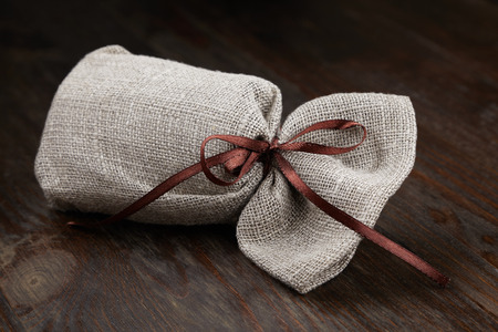 cloth bag with a gift, a pleasant surprise on dark bagroundの写真素材