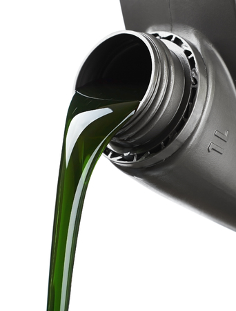 The oil for the engine flows, the open plastic canister, the green motor grease with molygenの写真素材