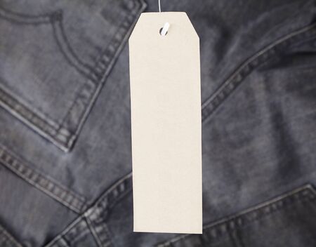 Paper tag on jeans, branded label on new pants