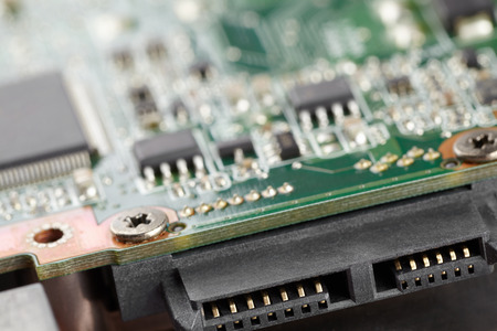 Interface connector for data transmission, green electronic board on background in backlight