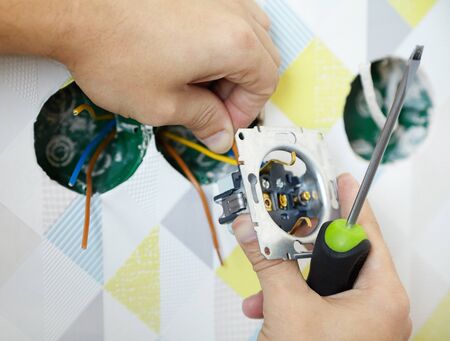 installation of an electrical outlet, work with an electric cable in home wiringの写真素材