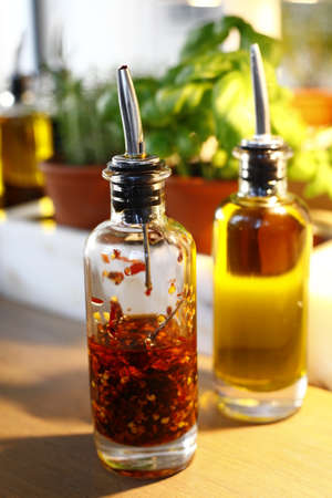 bottles of oil and vinegar on a wooden table