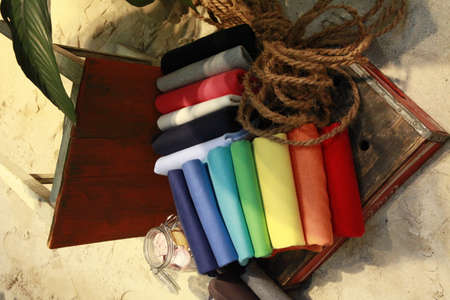 stack of sweaters in rainbow colors on wooden ground