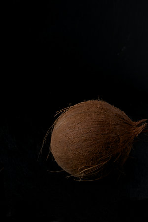 Coconut on a black background, close-up, selective focusの写真素材
