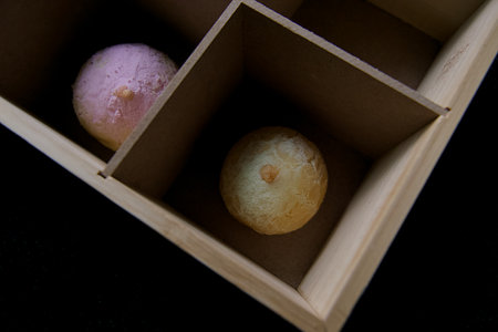 Japanese confectionery, mochi in wooden box on black backgroundの写真素材