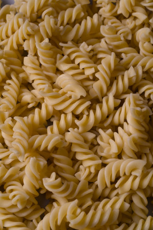 Fusilli pasta in a bowl, close-up, background