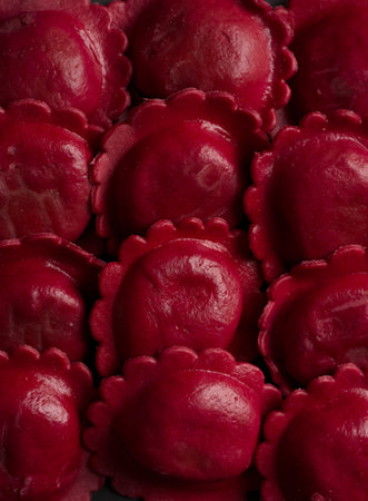 Red Italian ravioli on a black background. Toned.の写真素材