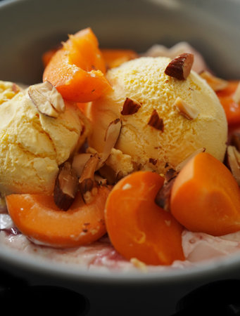 ice cream with persimmon and chocolate in bowl, closeupの写真素材