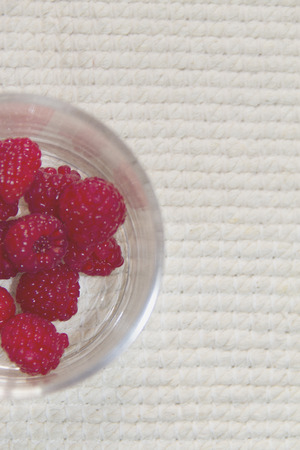 Pile of raspberries on white background