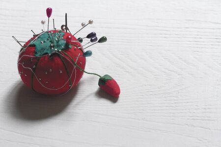 With Tomato pincer-shaped pins, thread and needle for sewingの写真素材