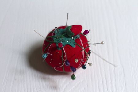 With Tomato pincer-shaped pins, thread and needle for sewingの写真素材