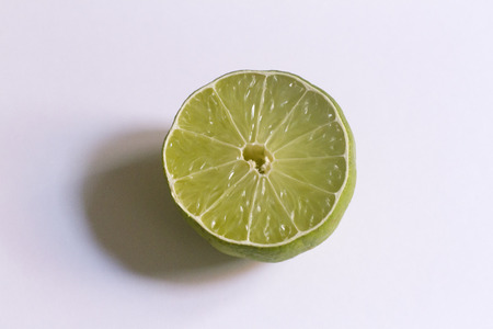 A slice of lime on a neutral background