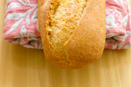 Tasty loaf of bread on a wooden surface