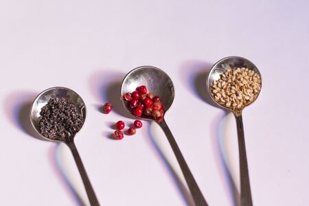 Round spoons with tasty spices for cookingの写真素材