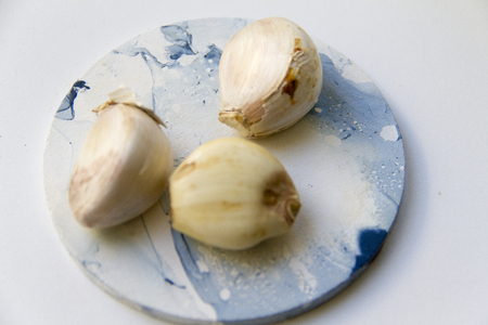 Garlic cloves on marble effect surfaceの写真素材