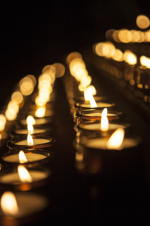 Burning votive candles in the church - close-upの写真素材