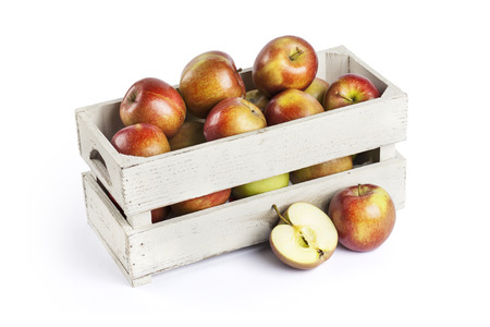 Wooden box of apples on white backgroundの写真素材