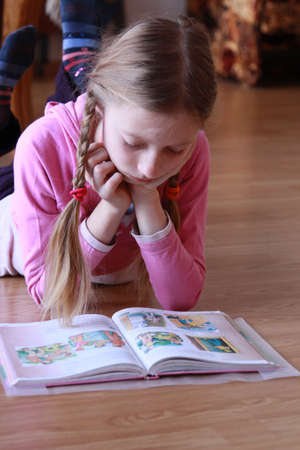 Girl reading a book at home 