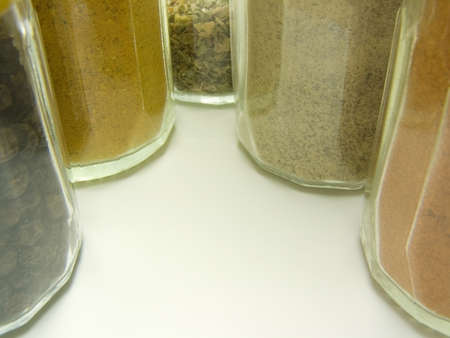 Ground spices in glass tableware and whole black pepperの写真素材
