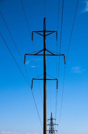 Electric power transmission on a background of the blue sky.