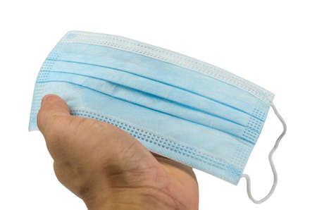 Hand holding medical protective mask on white background