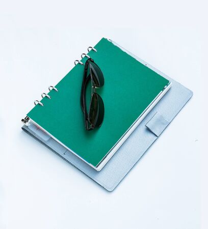 Sunglasses on a spiral notebook の写真素材