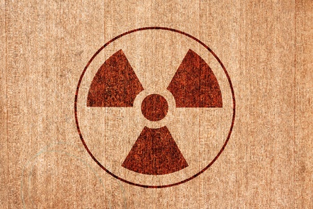 radioactivity warning symbol on wood backgroundの写真素材