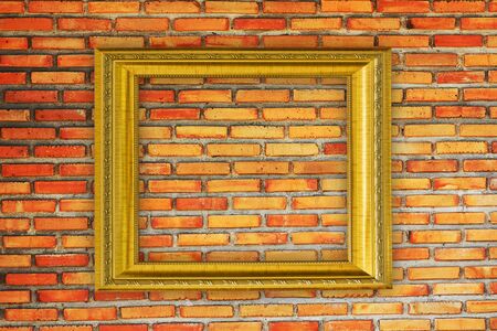 Golden Frame on old brick wallの写真素材