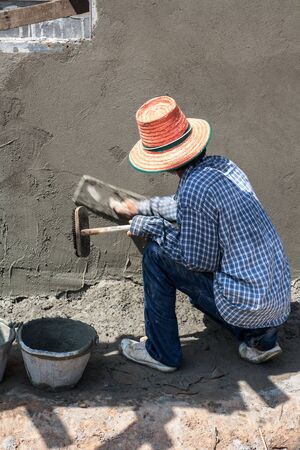 Sakon Nakhon, Thailand - September 19  Plasterer Myanmar plastering in construction work on September 16, 2011 in Sakon Nakhon, Thailand のeditorial素材