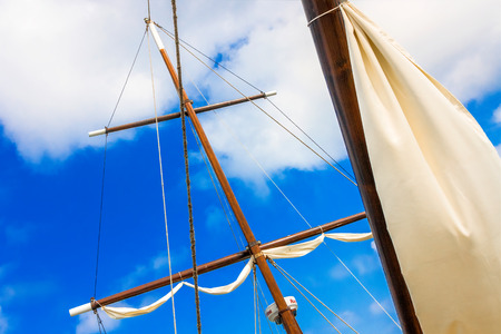 masts of sailing ships lying at the wharf skyline, blue sky with cloudsの写真素材