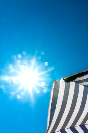 beach umbrella on blue sky backgroundの写真素材