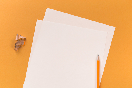 sharpen pencil with paper sheets on orange backgroundの写真素材