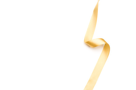golden satin ribbon isolated on white backgroundの写真素材