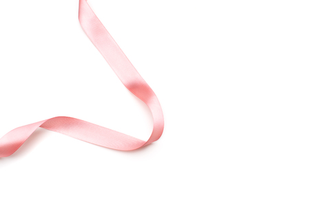 pink satin ribbon isolated on white backgrounの写真素材