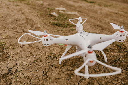 small drone with digital camera just before the start  on the groundの写真素材