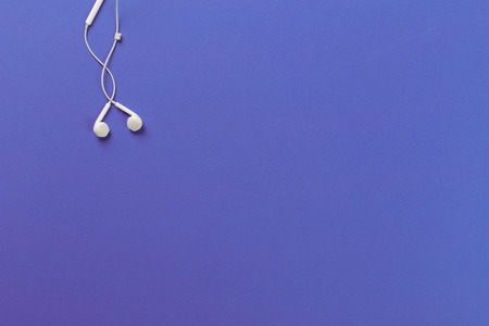 White earphones on violet backgroundの写真素材