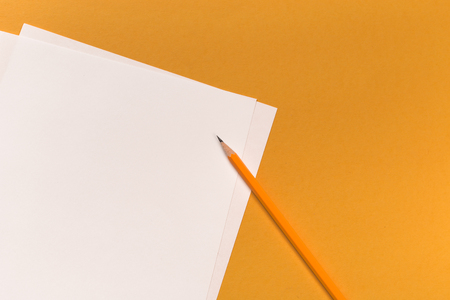 Pencils with sharpening shavings with white paper sheets on coloured backgroung, Office toolの写真素材