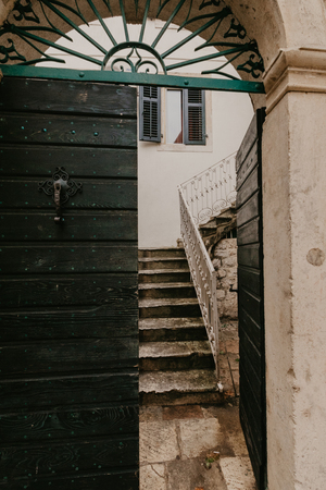 old green doors that lead to the courtyardの写真素材