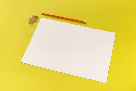 Pencils with sharpening shavings with white paper sheets on coloured backgroung, Office toolの写真素材