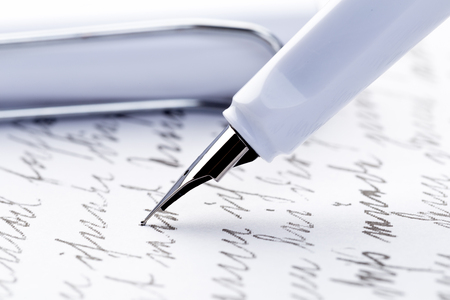 yellow fountain pen writing a letter