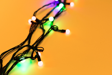 Christmas lights on yellow backgroundの写真素材