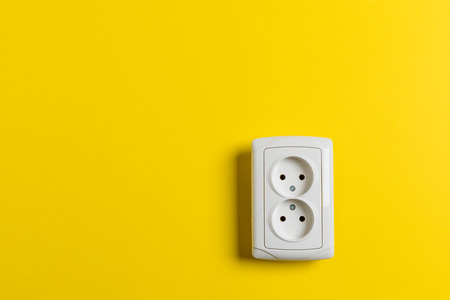 socket on yellow wallの写真素材