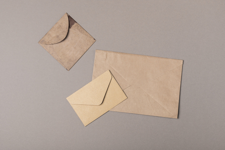 Brown craft envelopes on gray backgroundsの写真素材