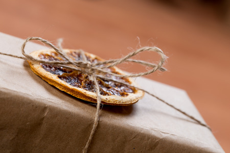craft presents decorated with dry citrus on wooden backgroundの写真素材
