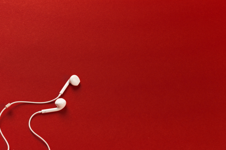 White earphones on red backgroundの写真素材