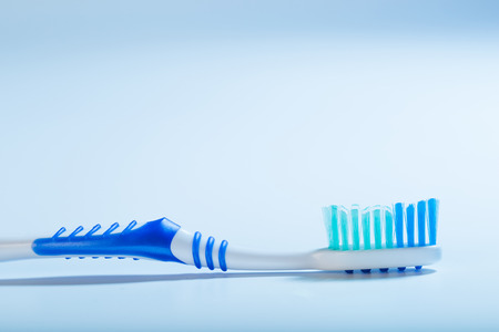 toothbrush on an blue background, close upの写真素材